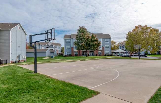 a basketball court in front of a row of houses