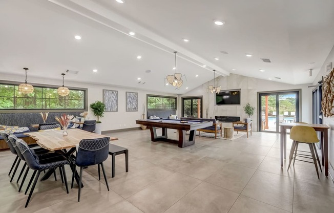 the entertaining room has a large table with chairs and a tv