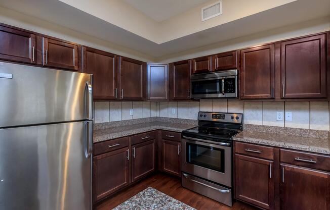 a kitchen with stainless steel appliances and wooden cabinets