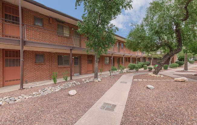 a path leading to a brick building