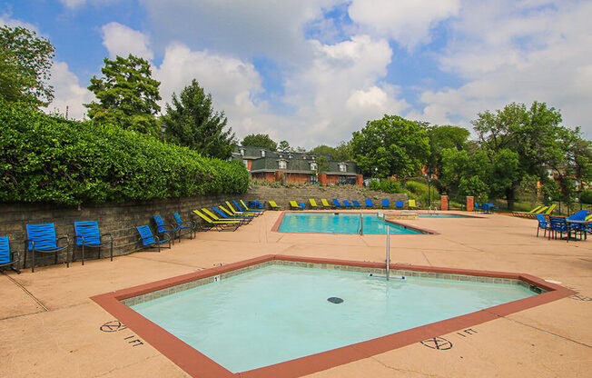 a swimming pool with chairs around it