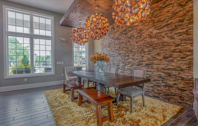 a dining table and chairs and a brick wall