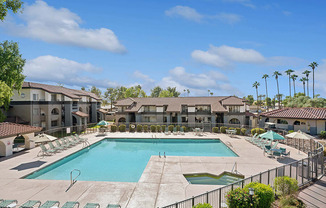 Community Swimming Pool with Pool Furniture at Stillwater Apartments located in Glendale, AZ.