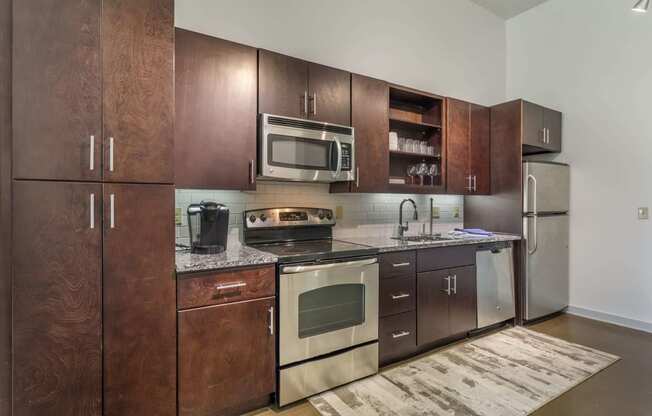 12 South Nashville TN apartments a kitchen with dark wood cabinets and stainless steel appliances