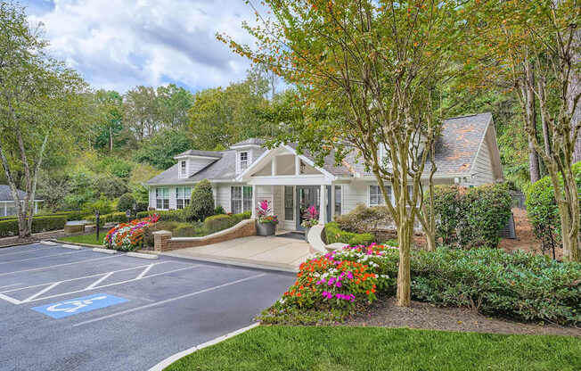 A parking lot with a handicap parking space in front of a building.