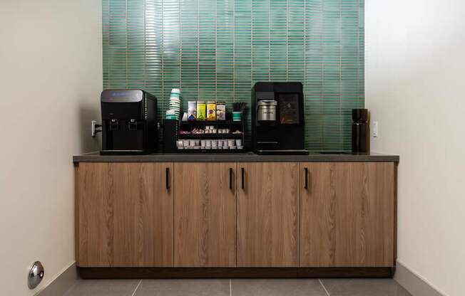 A row of coffee machines on a counter.