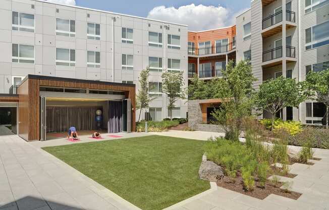 people playing in the courtyard of an apartment building