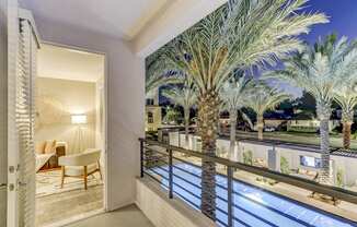 Balcony with a pool and palm trees at Array La Mesa, La Mesa California