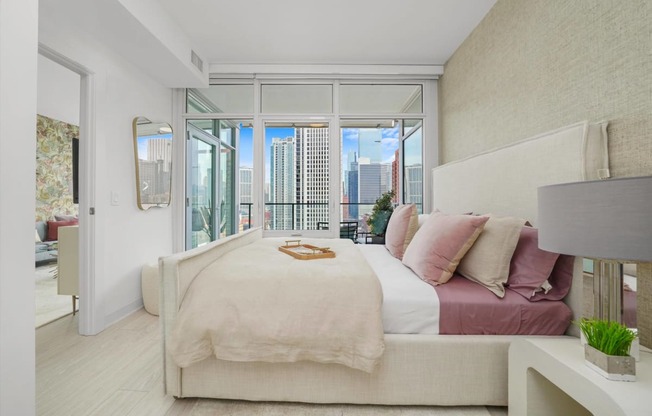 a bedroom with a bed and a large window