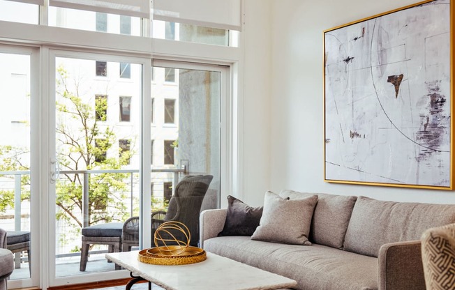 a living room with a couch and a table and a balcony at 20 Midtown, Birmingham, Alabama