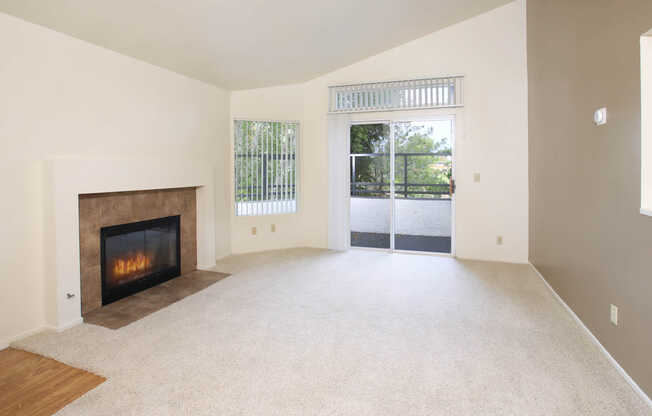 Carpeted Living Room with Fireplace and Balcony