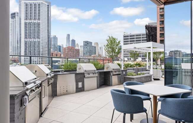 a rooftop patio with tables and chairs and a view of the city  at Cassidy on Canal, Illinois, 60606