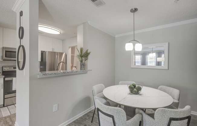 Model home dining area with kitchen overlooking
