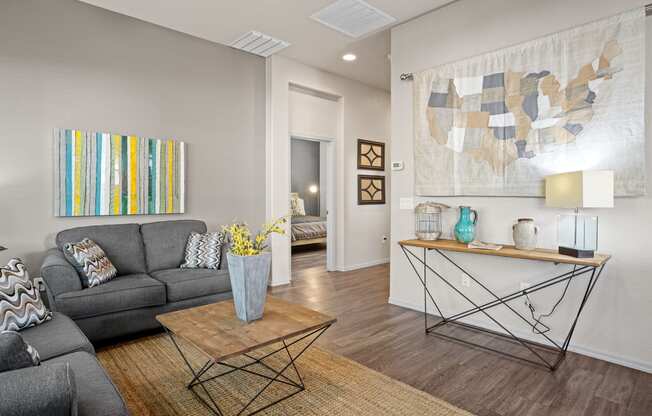 a living room with a gray couch and a coffee table