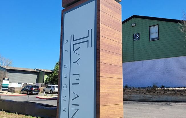 a monument with a clock on the side of a street at Ivy Plains at Brooks Apartments, San Antonio , Texas