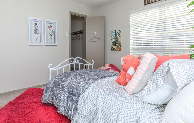 furnished bedroom with a red throw rug