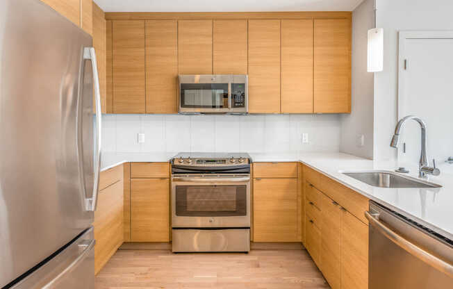 Kitchen with Glass Tile Backsplash and Stainless Steel Appliances