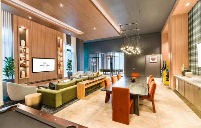 Layered seating, warm wood details, and integrated screens create a media room designed for group viewing, casual gatherings, and relaxed entertainment.