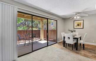 a dining room with sliding glass doors to a patio at Summerwood Apartments, Santa Clara, CA 95050