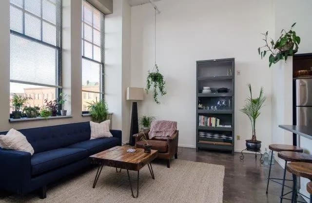 a living room with a blue couch and a table