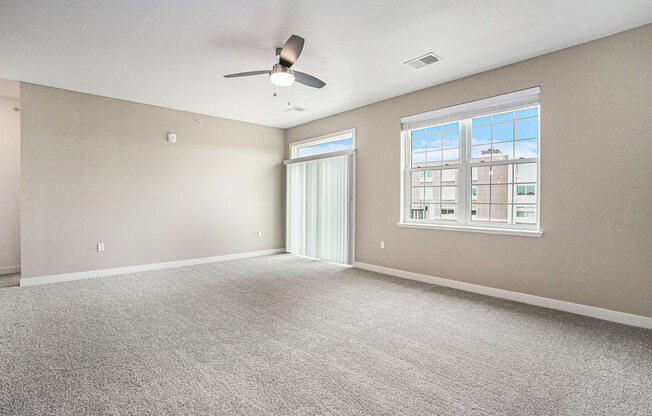 an empty bedroom with a ceiling fan at Meadowbrooke Apartment Homes, Michigan