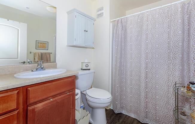 a white sink sitting next to a shower