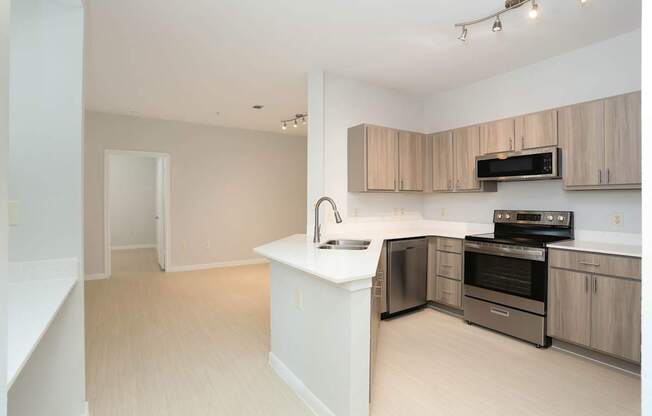 A kitchen with a white island and stainless steel appliances.