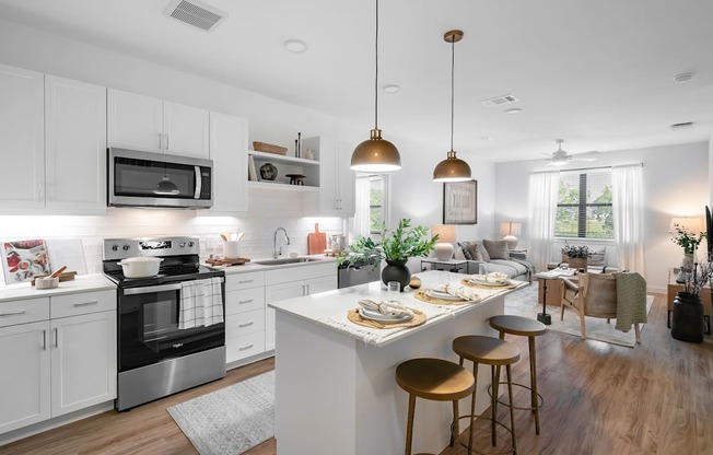A modern kitchen with a large island and bar stools.