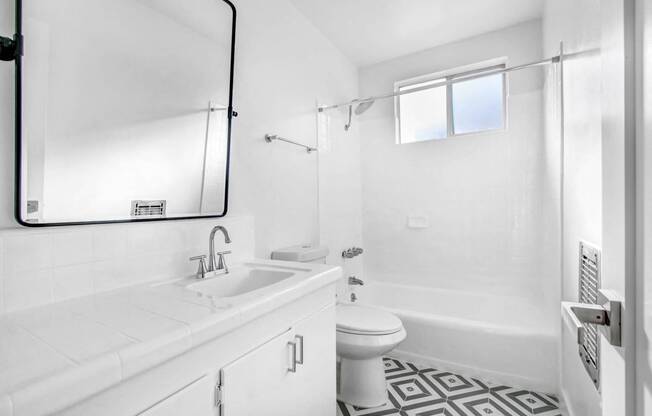 a white bathroom with a sink and a toilet