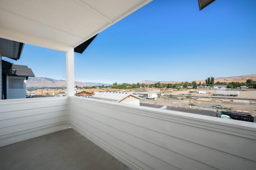 a balcony with a view of a city and a blue sky at Gateway Apartments, Washington, 98802