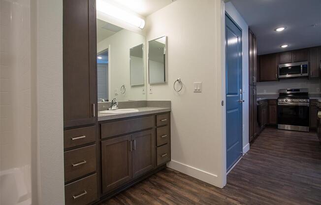 a bathroom with a sink and a mirror at Loma Villas Apartments, San Bernardino, 92408