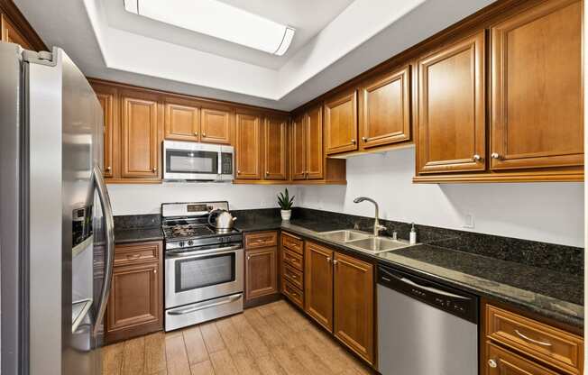 a kitchen with wooden cabinets and stainless steel appliances