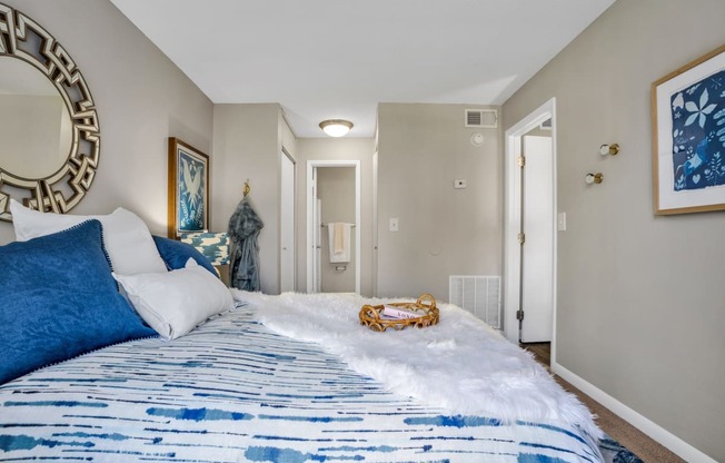 a bedroom with a bed and a mirror