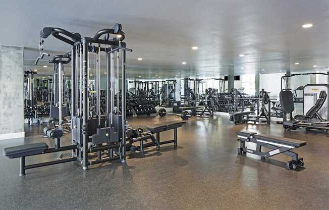 A gym with a variety of equipment including a leg press machine.