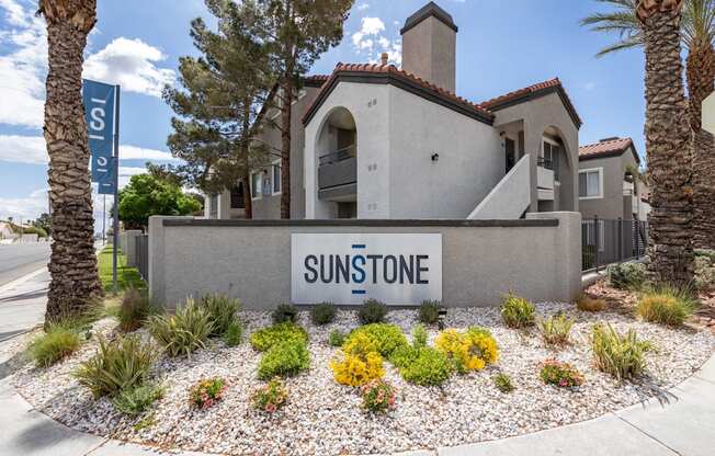 A house with a sign that says Sunstone in front of it.