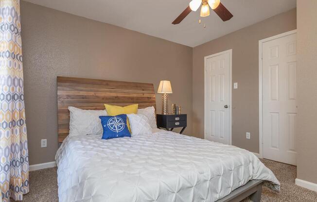 a bedroom with a bed and desk in a room