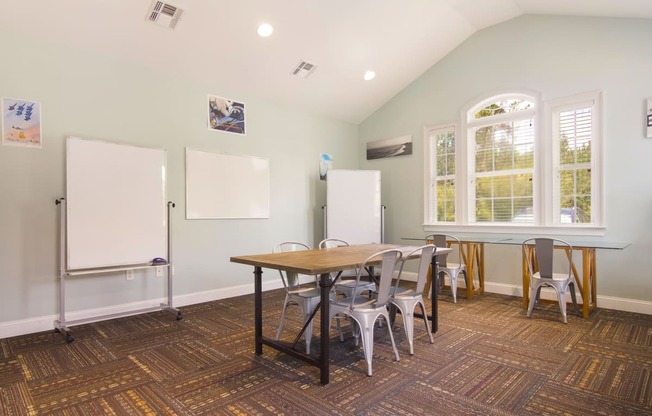 Spacious and well-equipped meeting area with a large table and chairs at Angel Landing apartments in Pensacola, FL