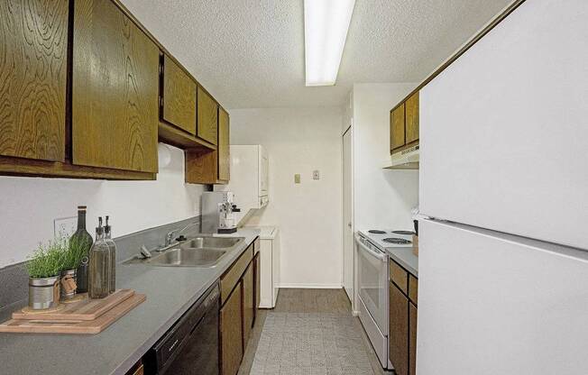 A kitchen with wooden cabinets and a white refrigerator.