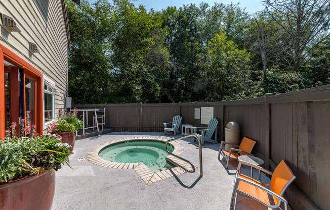 a backyard with a pool and patio with chairs and a table at Quartz Creek, Washington, 98043