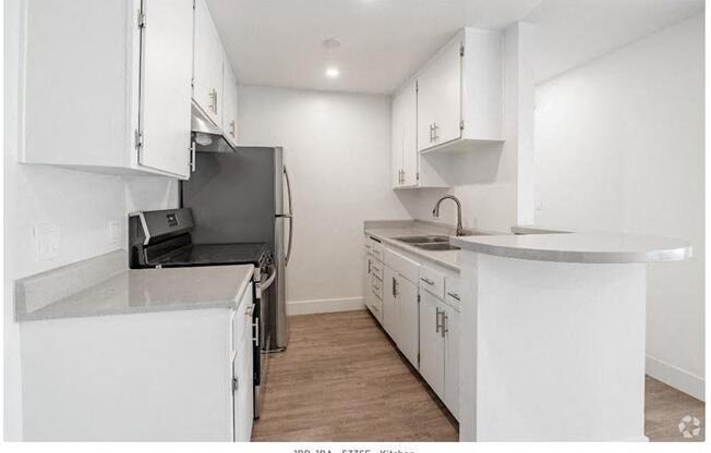 a kitchen with white cabinets and a stove and a refrigerator