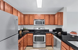 a kitchen with wooden cabinets and stainless steel appliances