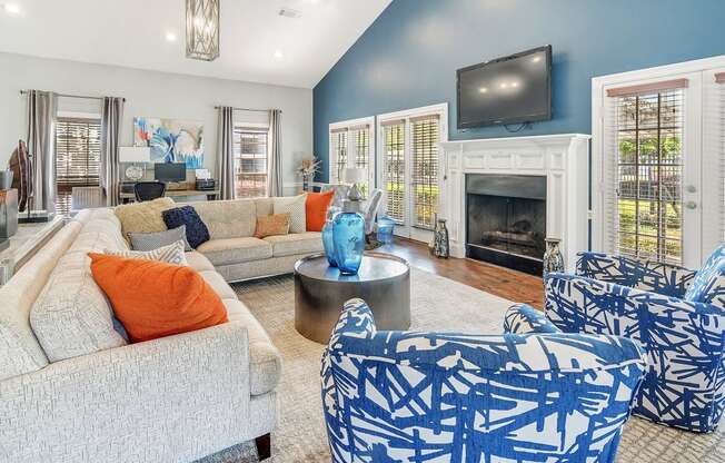 a living room with blue and white furniture and a fireplace at Reserve of Jackson Apartment Homes, Jackson, MS