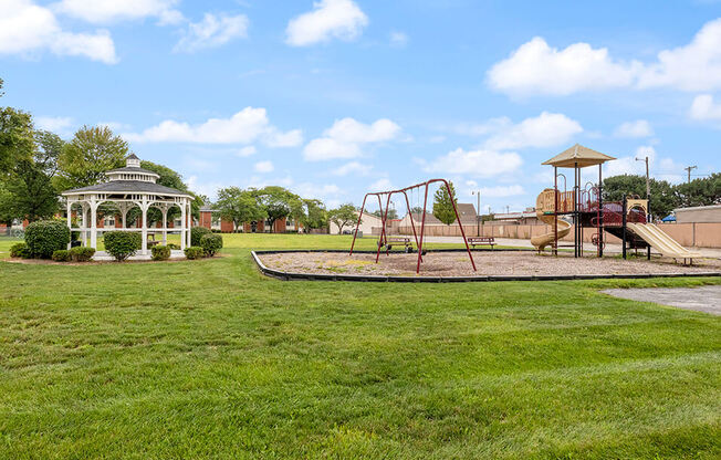 a playground with a gazebo and a swing set