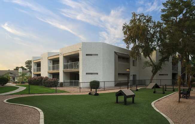 a building with a lawn and trees in front of it