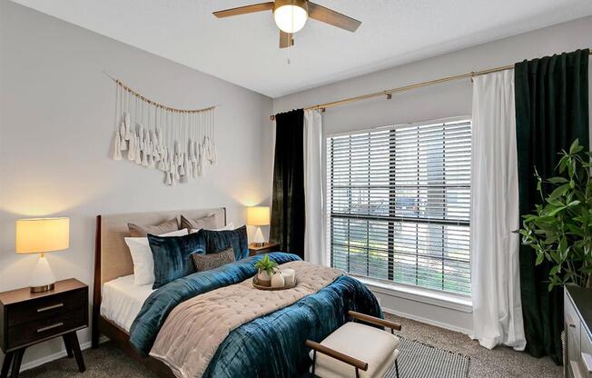 a bedroom with a bed and a ceiling fan