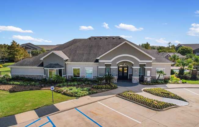 the front of a house with a driveway and a tennis court at Sladestone Shadow Creek, Pearland, TX