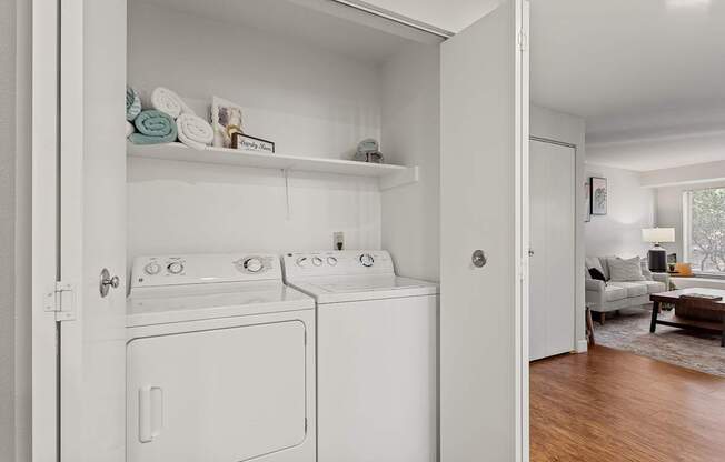 A white laundry room with a washer and dryer.