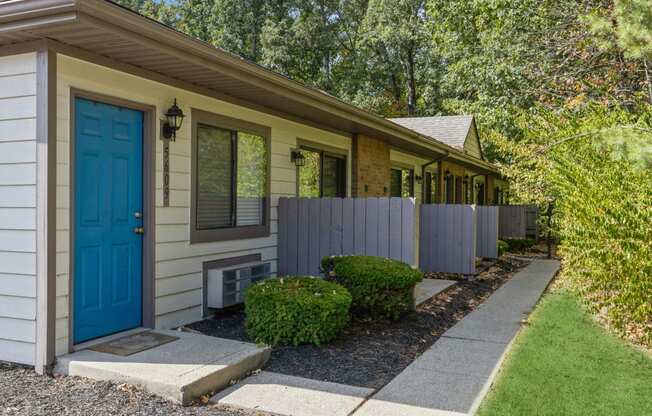 a blue door on the side of a house