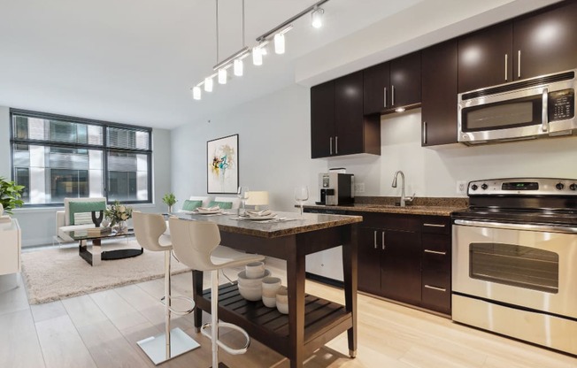 an open kitchen and living room with a table and chairs