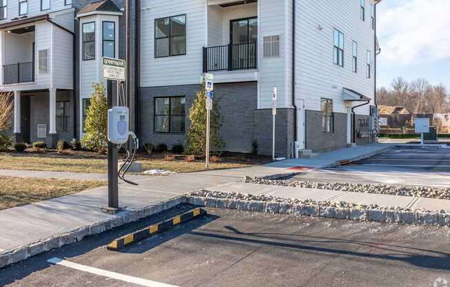 A street view of a residential area with apartment buildings and a parking meter.